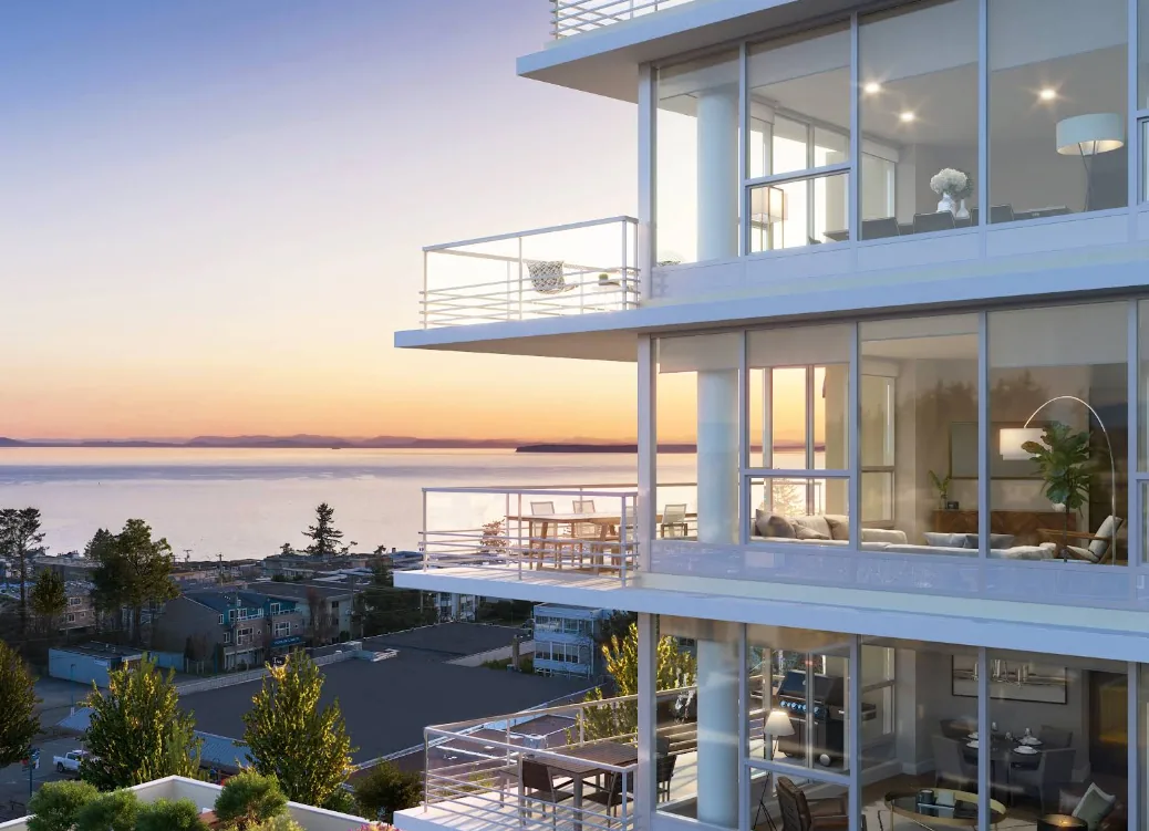 Monaco Solterra — coastal residential tower in BC with floor-to-ceiling window wall and glass balcony railings at sunset
